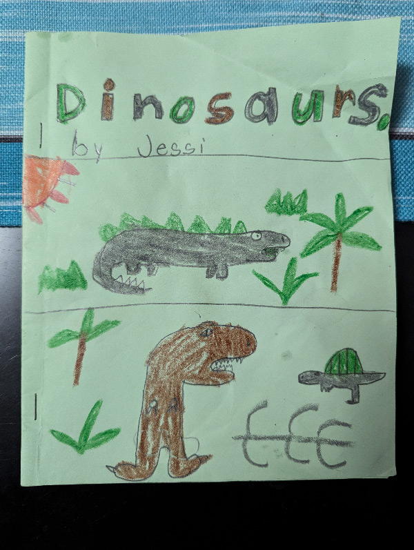 Cover of a dinosaur book with child drawings of several dinosaurs in green, grey, and brown