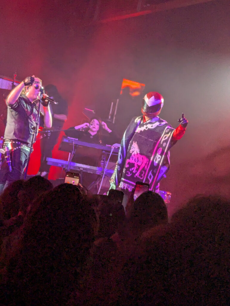Proto Man and Panther on stage singing Sons of Fate