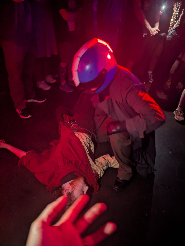 Mega Man and Proto Man cosplayers acting out a scene from a Protomen song in the middle of a crowd